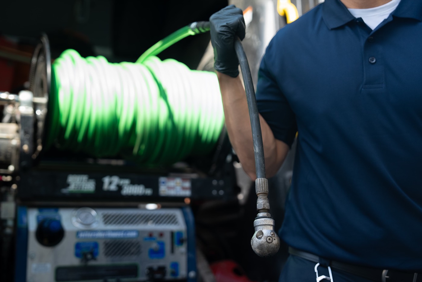 Technician running a hydro jetting hose